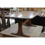 An Ercol elm coffee table on bracket supports.
