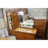 An Edwardian inlaid mahogany bedroom suite comprising a double wardrobe with 2 mirrored doors above