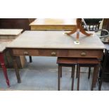 A Victorian oak library desk with 3 frieze drawers either side raised on cylindrical turned legs.