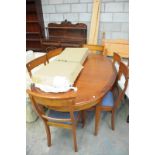 A Reproduction oval extending dining table with 2 extra leaves  and 6 conforming dining chairs.