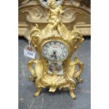 A gilt Spelter and porcelain mantle timepiece,