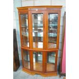 A Reproduction bow front yew wood wall display cabinet .