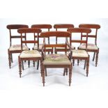 A set of seven William IV mahogany dining chairs
Comprising an elbow chair with a shaped cresting