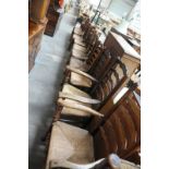 A Harlequin matched set of twelve Ash and Elm ladder back dining chairs
With turned finials the