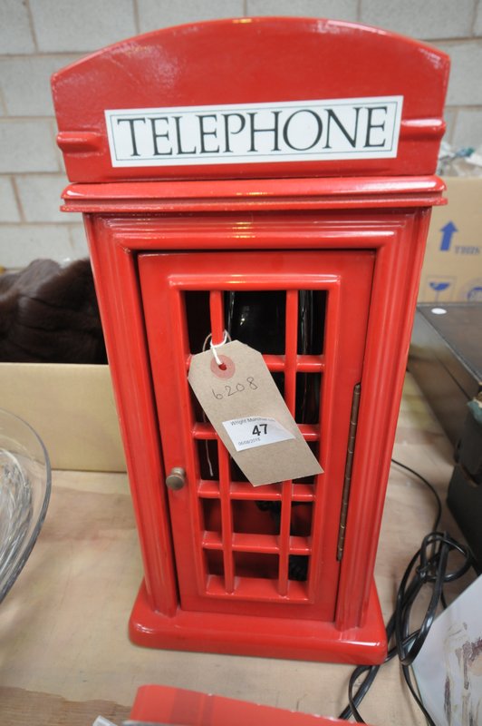 A Red telephone box novelty telephone.