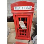 A Red telephone box novelty telephone.