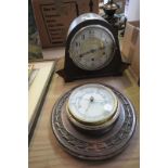 An Early 20th century oak cased mantel clock and a carved oak wheel barometer.