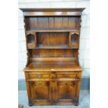 A Reproduction George III style oak dresser with a cavetto cornice above a plain frieze and 2