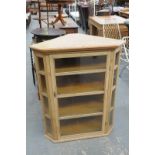 A Pine hanging corner cupboard with a single 4 panel glazed door.