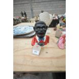 A Painted metal novelty figural money box.