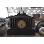 A Victorian architectural black slate mantel clock with a gilt metal dial and gilt metal fruit