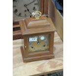 An Elliot of London walnut cased mantel clock with a gilt dial and silvered chapter ring with a 2