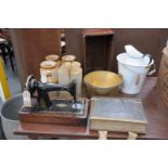 An Early 20th century walnut cased sewing machine, stoneware storage jars and flagons,