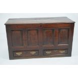 An early 18th Century oak mule chest
The rectangular cleated hinged plank top above a plain frieze