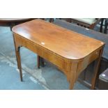 An Early 19th century mahogany folding tea table on legs of tapering square section. CONDITION