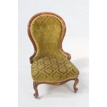 A Victorian rosewood drawing room chair 
The curvilinear waisted button back with a green leafy