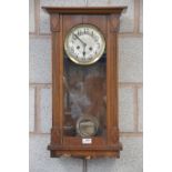 An Early 20th century wall clock with a silvered dial.