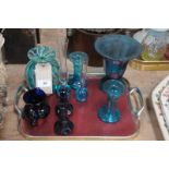 A Tray of coloured glass items including a spirally decorated bottle shaped vase, candle sticks,