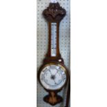 An early 20th Century carved oak banjo barometer.