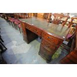 A Reproduction mahogany leather inset twin pedestal writing desk.