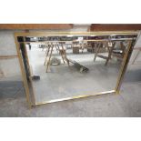 A Modern rectangular bevelled wall mirror with a gilt wood and mirrored frame.