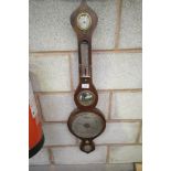 A 19th century mahogany onion topped wall barometer with a silvered dial.
