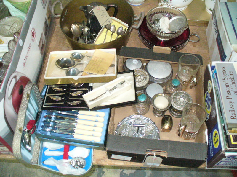 Assorted metal ware including a brass skellet, loose cutlery , dressing table jars, cased cutlery,