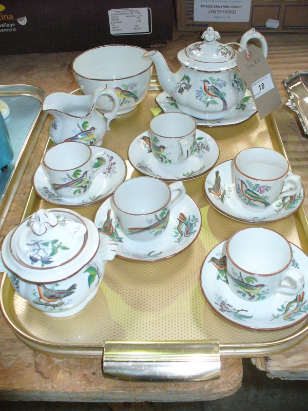A 19th Century earthenware  tea service decorated with birds comprising  teapot, sugar basin ,