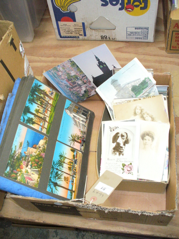 A Large collection of loose vintage postcards and a postcard album.