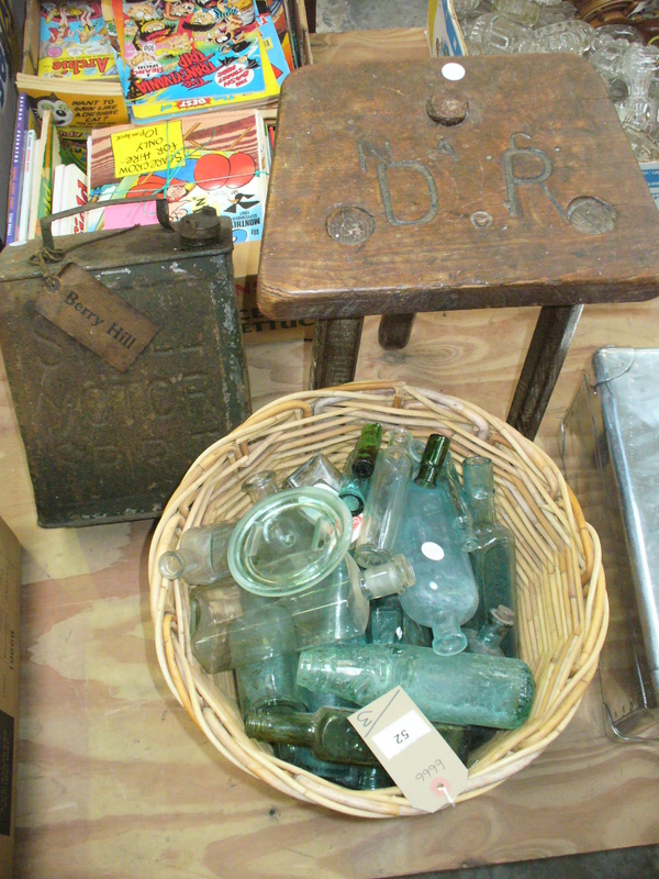 A Collection of old glass bottles to a wicker basket,