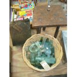 A Collection of old glass bottles to a wicker basket,