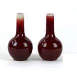 A pair of Chinese sang de boeuf bottle vases, 20th Century
Each with a globular body, rising to a