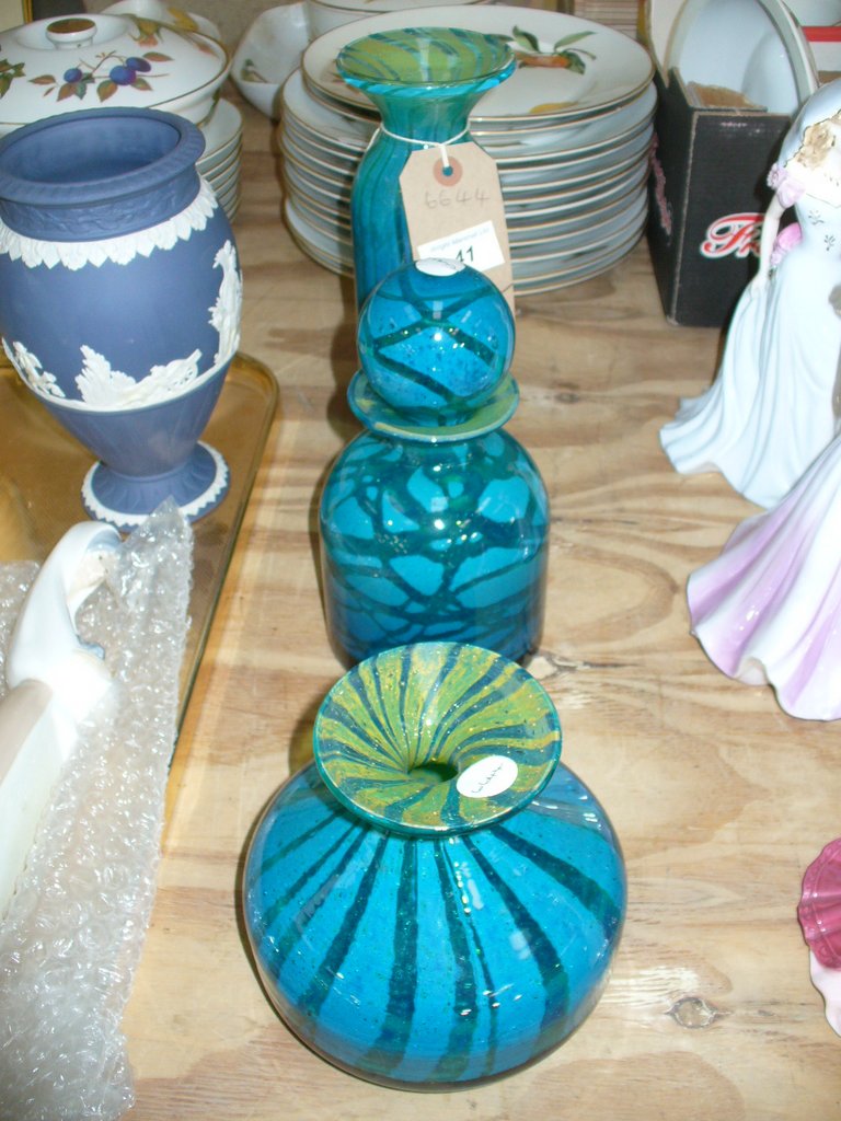 A Mdina coloured glass cylindrical vase, a Mdina decanter and stopper and a bulbous vase.