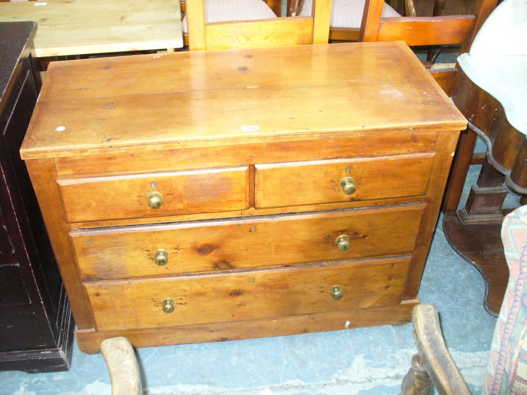 A Pine chest of 2 short and 3 long drawers, brass knob handles.