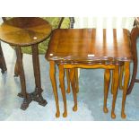 A Reproduction nest of 3 yew wood tables and a segmentally veneered pedestal table.