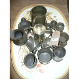 14 Assorted pewter tankards and measures .
