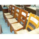 A Set of 5 hardwood rush seated ladder back chairs.