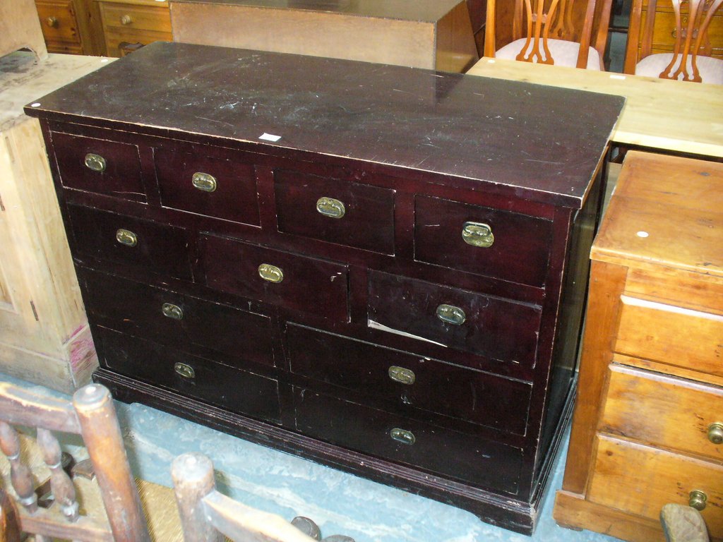 A Modern hardwood storage chest with 11 drawers.