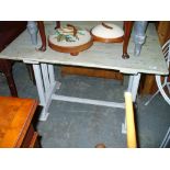 A Shabby chic painted pine rectangular kitchen table.
