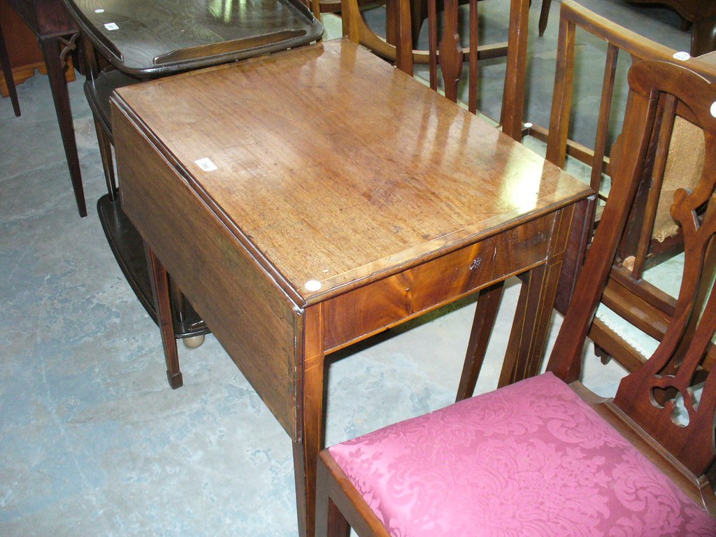 A 19th Century inlaid mahogany Pembroke table on legs of tapering square section.