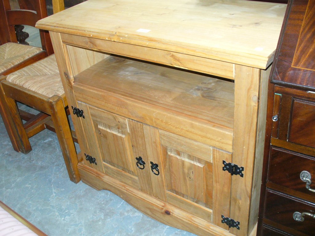 A Modern pine side cabinet with 2 cupboard doors.