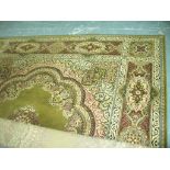 A Persian pattern  wool carpet with a green ground.
