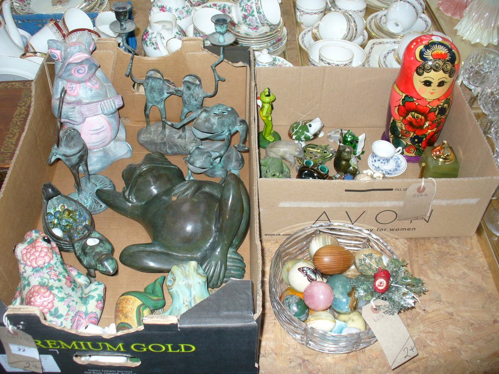 A Collection of frog figures including composition and metal examples, a collection of marble eggs,