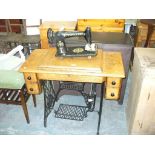 An Oak cased Singer treadle sewing machine.