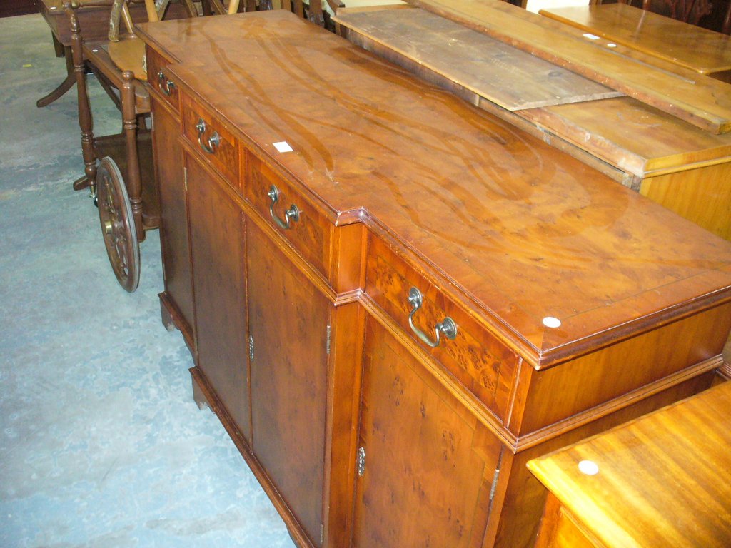 A Reproduction yew wood break front sideboard.