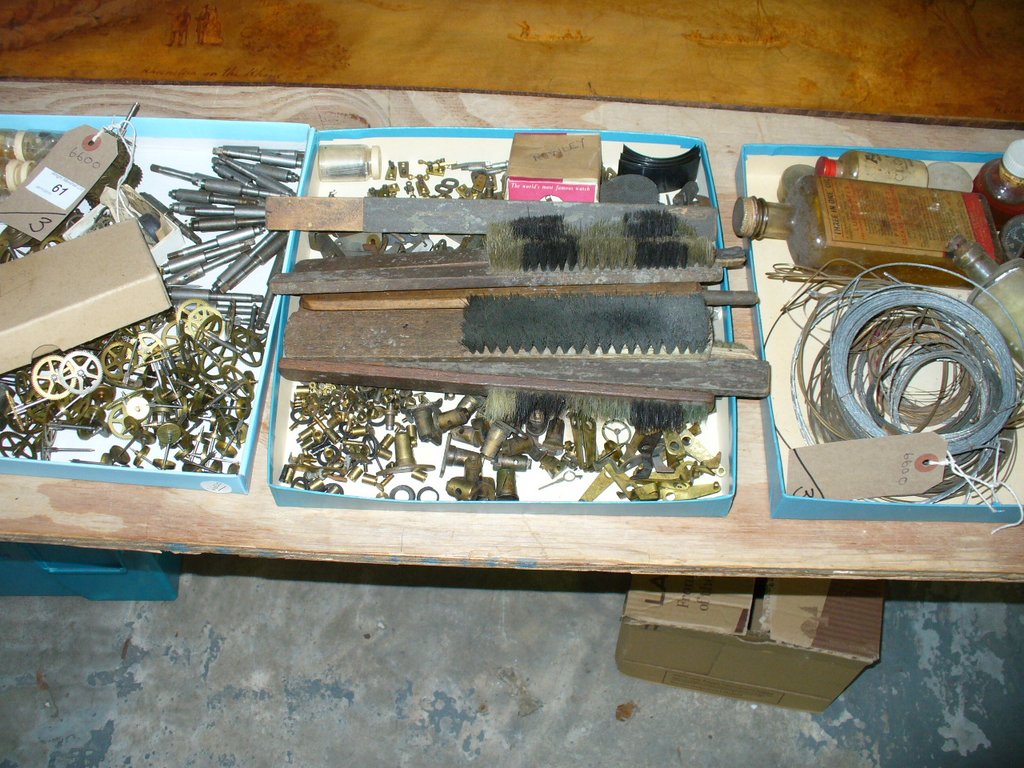 A Collection of watch and clock parts , brass cogs and fittings, qty to 3 trays.