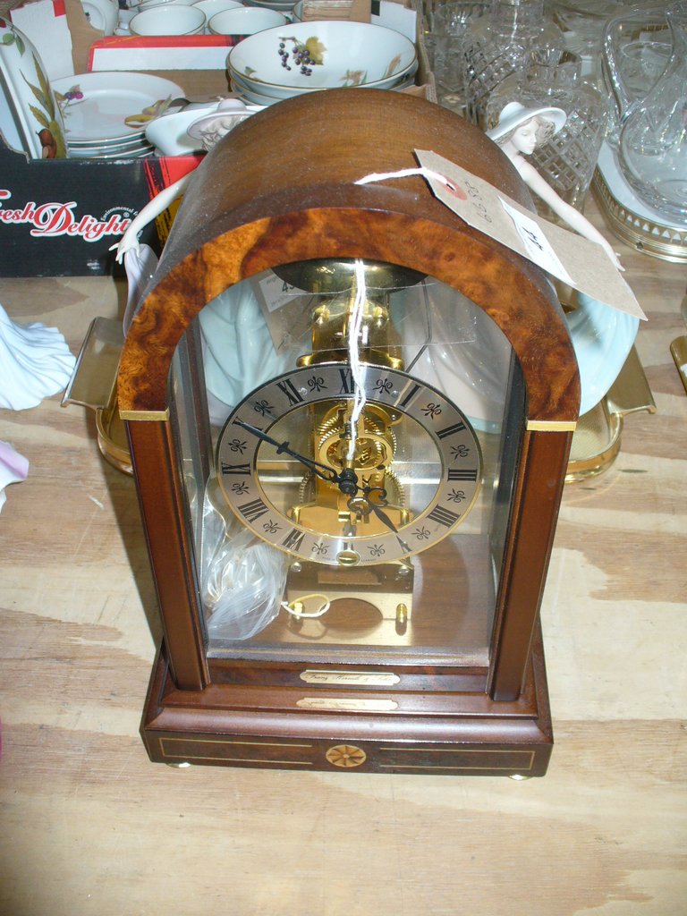 A German reproduction mantel timepiece with a silvered bezel dial and Roman numerals.