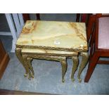 A Nest of 3 onyx and brass tea tables.