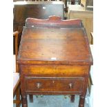 A Victorian stained pine clerks desk with a hinged slope above a single drawer.