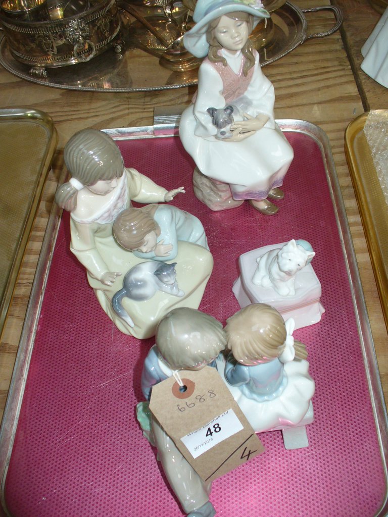 A Nao group , two children sat on a bench, a Lladro group two children with a kitten,